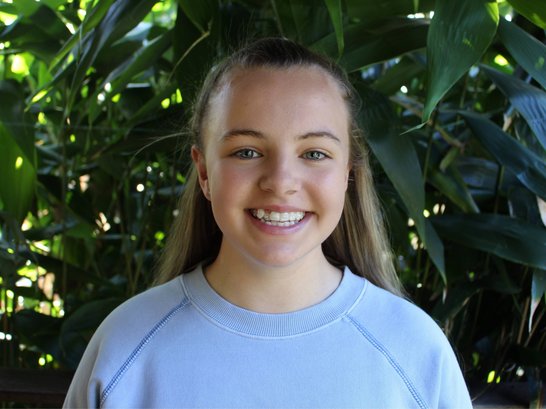 Georgia Ryan, wearing a blue jumper and smiling.